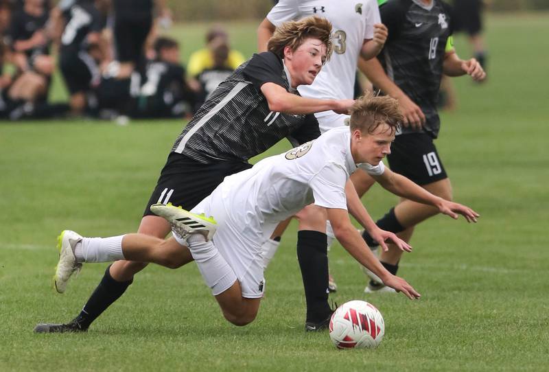 Kaneland's Matthew Mitchinson (top) and Sycamore's Aiden Sears get tangled up going after the ball during their game Wednesday, Sept. 6, 2023, at Kaneland High School in Maple Park.