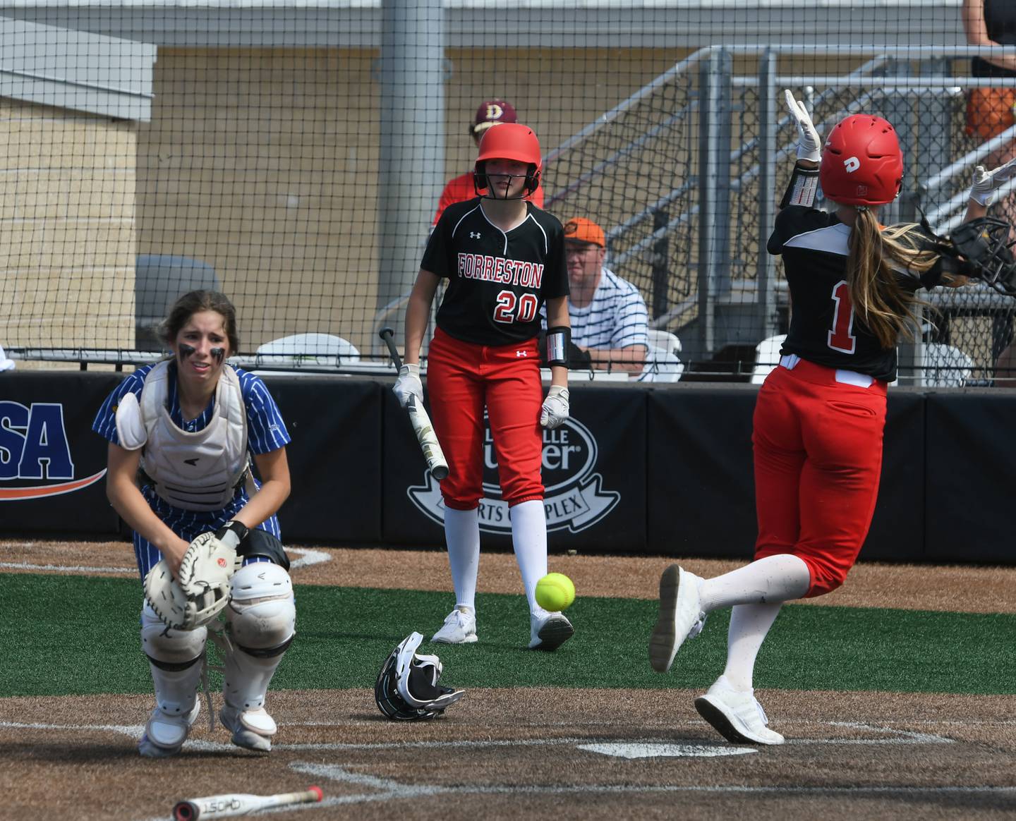 Forreston's Rylee Broshous (1) celebrates after scoring a run against Newark as Jenna Greenfield (20) watches during action in the third place game of the 1A state softball tournament in Peoria on June 4. The Cardinals won the game 4-2.