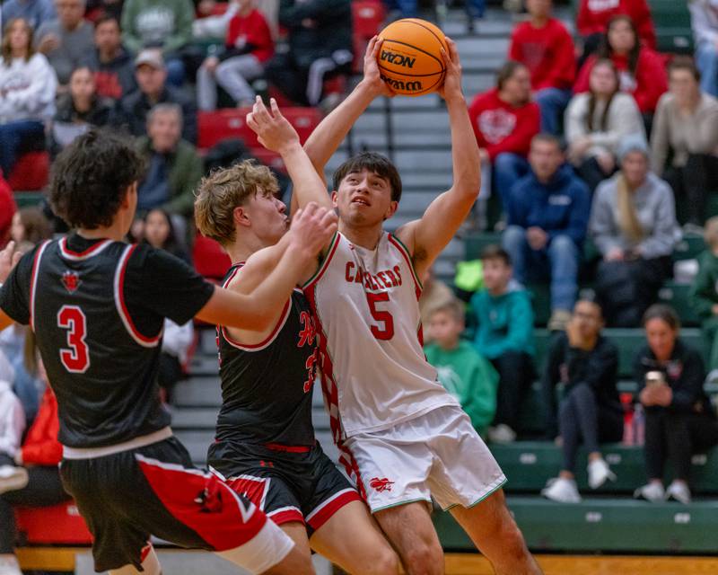 Erick Sotelo of LaSalle-Peru High School puts a shot up against Hall defenders during the game at Sellett Gymnasium on December 2, 2025 at LP High School.