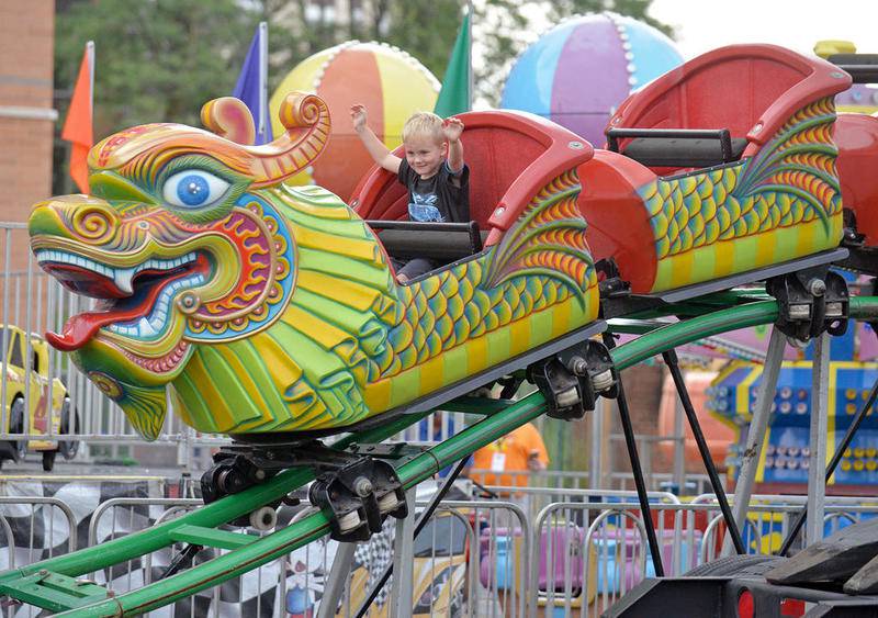 Jack O'Brien, 5, of La Grange, is waves his hands riding the Orient Express at the La Grange Endless Summer in Gordon Park on Saturday, Aug. 5, 2017.