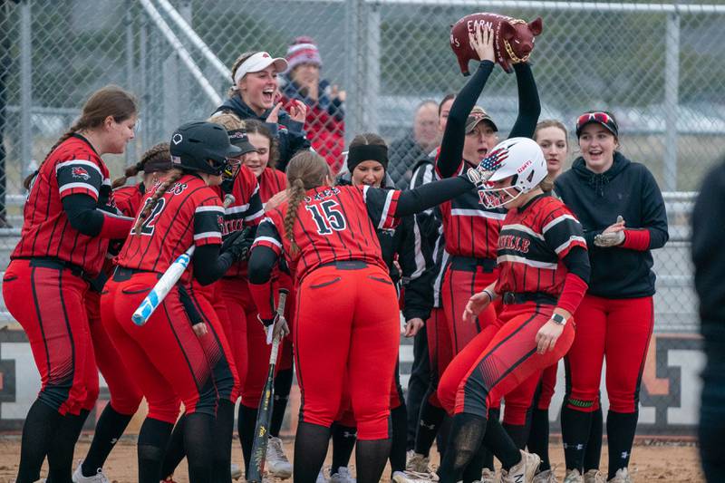 Yorkville's Sara Ebner (14) is greeted by her team after hitting a homer against St.Charles East during a softball game at St.Charles East High School on Wednesday, Mar 22, 2023.