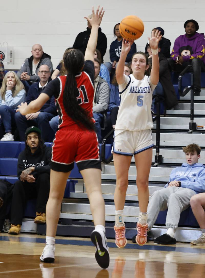 Nazareth's Sophia Towne (5) takes a three-point shot during the girls varsity basketball game between Bolingbrook high school and Nazareth Academy on Monday, Jan. 12, 2026 in La Grange Park.