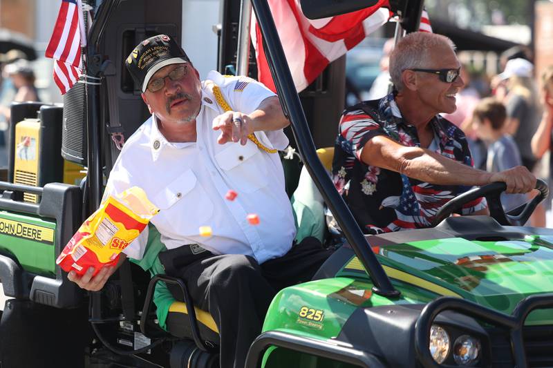 A member of the American Legion Post 935 throws out candy to the crowds in the Manhattan Labor Day Parade on Monday, Sept. 4, 2023 in Manhattan.