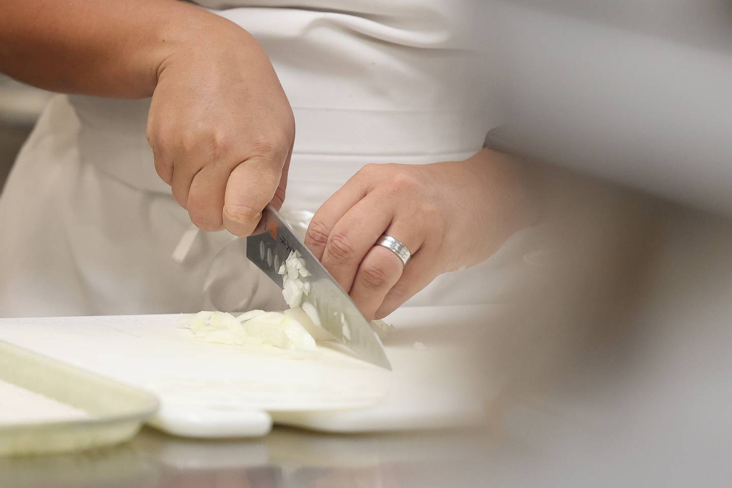 Joliet Junior College Chef Katey Sopko demonstrates cutting an onion with her class at the City Center Campus. Monday, Aug. 29, 2022, in Joliet.