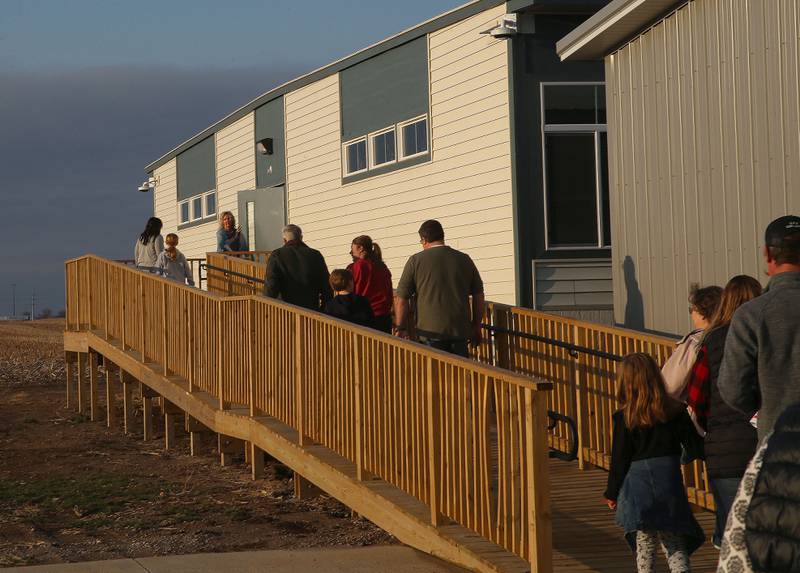 Waltham School suprientendent Kristi Eager leads a tour of Utica residents to the mobile classrooms on Thursday, March 27, 2025 in Utica.
