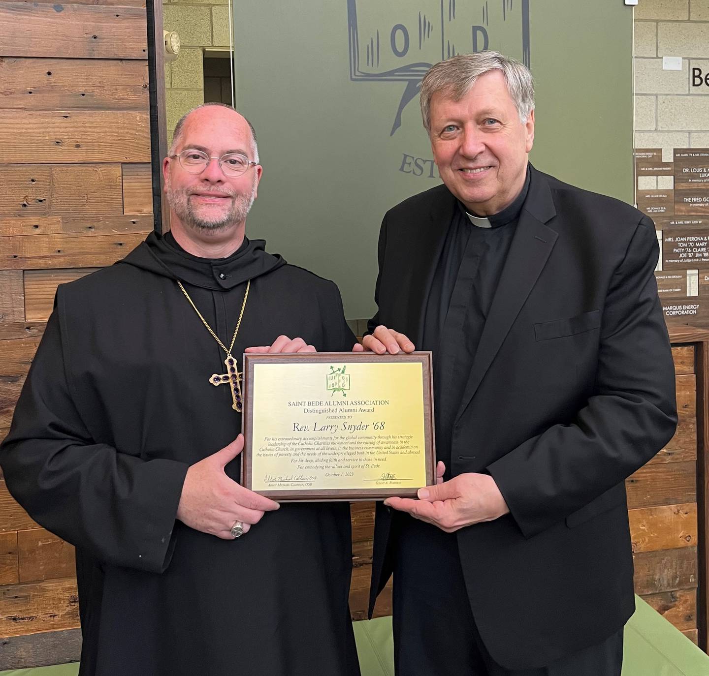 Abbot Michael Calhoun, OSB 1989 (from left) presents the 2023 Distinguished Alumni Award to the Rev. Father Larry Snyder, Class of 1968, during the annual Bruins Brunch on Sunday, Oct. 1, 2023.