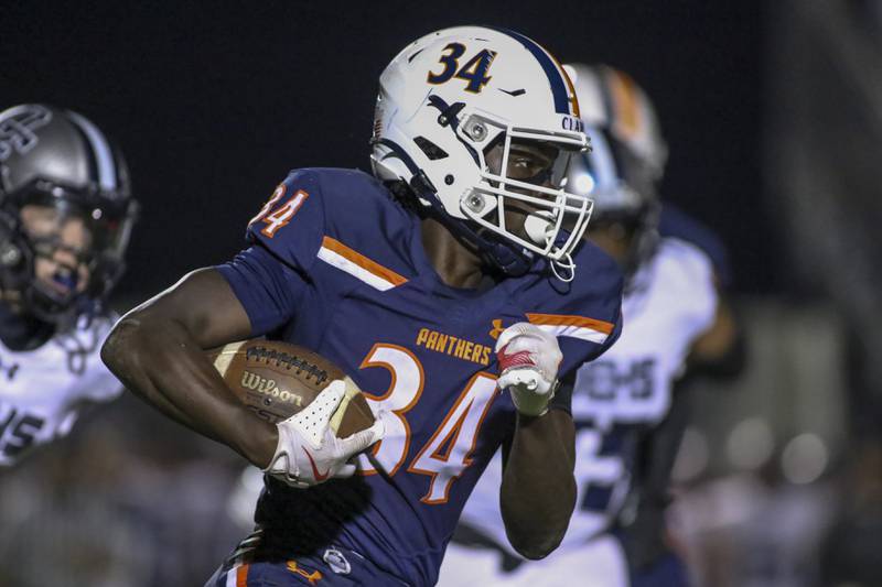 Oswego's Ammar Banire (34) runs with the ball during football game between Oswego East at Oswego Friday, Oct 17, 2025 in Oswego.