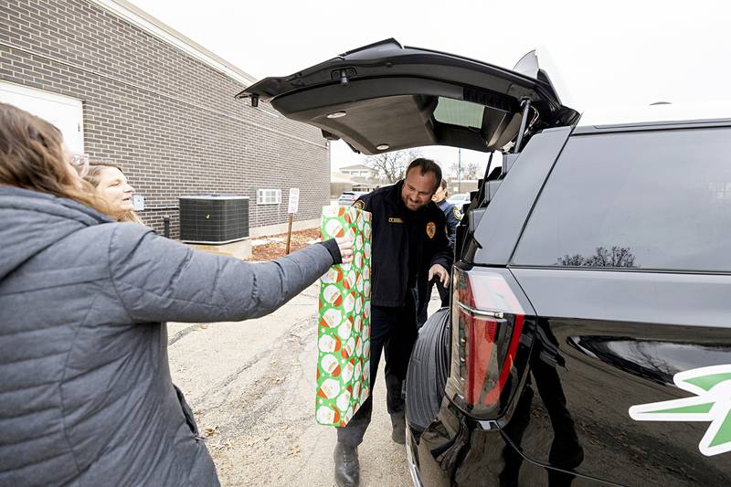 Rock Falls Police Chief Ryan McKanna loads gifts into a squad Monday, Dec. 22, 2025, for the department’s Operation Santa. Nine families were treated to gifts, food and house supplies from donations raised by the RFPD.