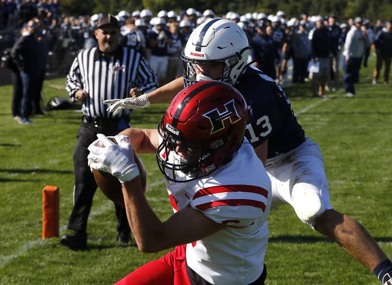 Huntley's Jacob Witt catches a touchdown pass in front of Cary-Grove's Corey Adams during a Fox Valley Conference football game on Saturday, Oct. 7, 2023, at Cary-Grove High School.