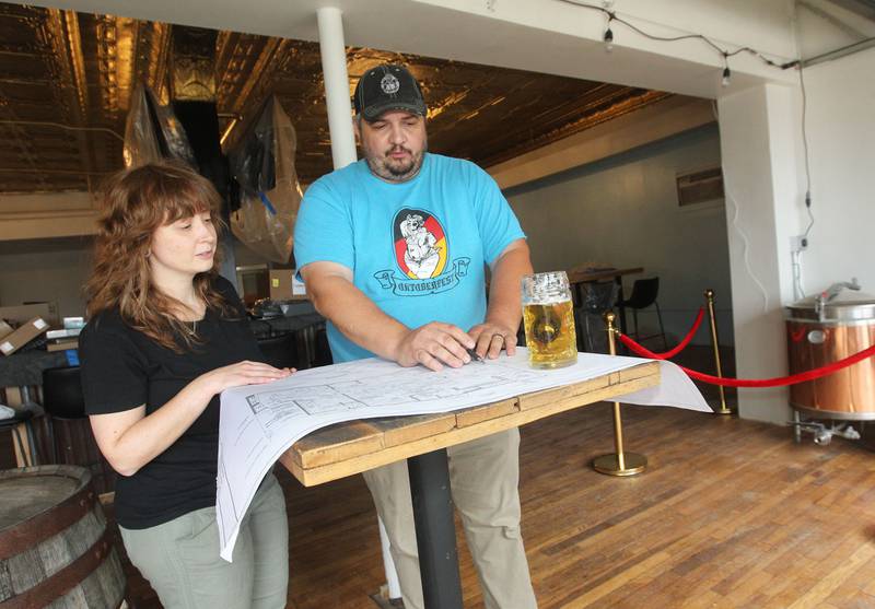 Joshua Grubbs, president/brewer, (on right) goes over blueprints with Sarina Parl, of Lake Villa, beertender, for the taproom at the Black Lung Brewing Company’s new location under construction in Fox Lake on Monday, June 26, 2023. The small brewery from Round Lake Beach has started a Kickstarter fundraiser called, Black Lung Expansion to Fox Lake. The grand opening for Black Lung Brewery Fox Lake is on July 22nd from 3-5pm. 
Image by Candace H. Johnson for Shaw Local News Network
