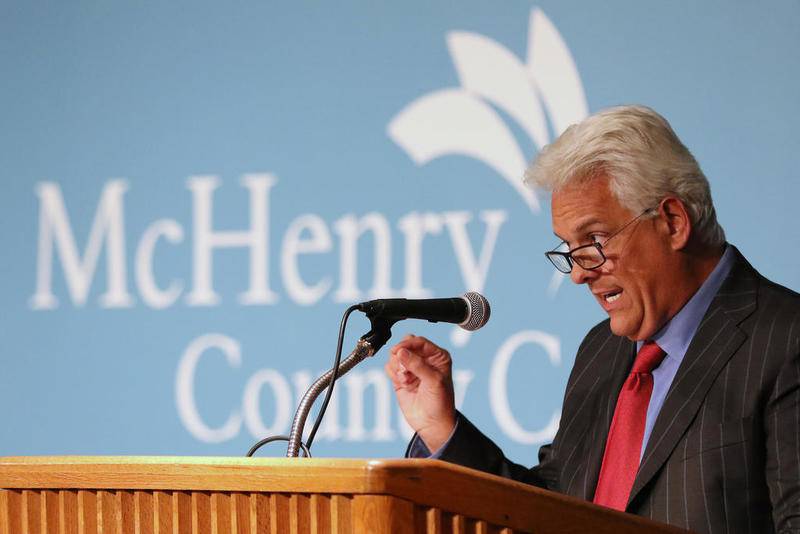 McHenry County Board Chairman Jack Franks speaks Jan. 30 at the lectern during a League of Women Voters forum discussing the dilemma of an elected coroner's office at McHenry County College in Crystal Lake.