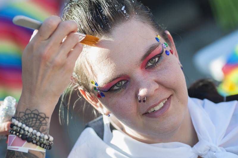 Raven Kay of Prophetstown gets some extra flash from Maggie Love Saturday, June 18, 2022 at Dixon’s Pride Fest. Fusion Salon in downtown Dixon was on hand to offer customers some fun hair and makeup options.