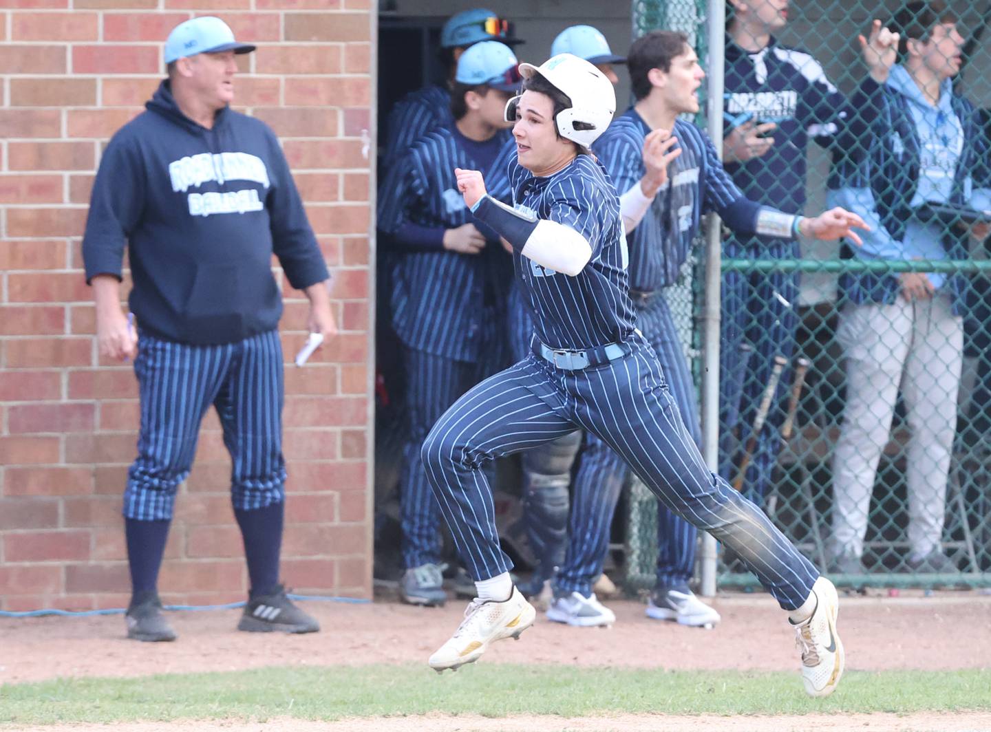 Nazareth's Jaden Fauske (21) runs home during the varsity baseball game between Benet Academy and Nazareth Academy in La Grange Park on Monday, April 24, 2023.