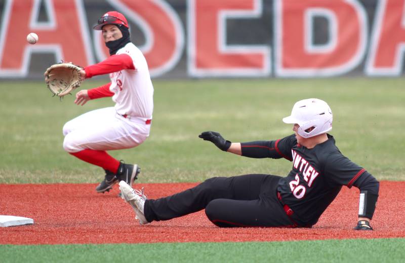 Barrington’s Noah Rasmussen, left, fields the throw as Huntley’s Haiden Janke slides safely with a steal of second base in varsity baseball at Barrington Saturday.