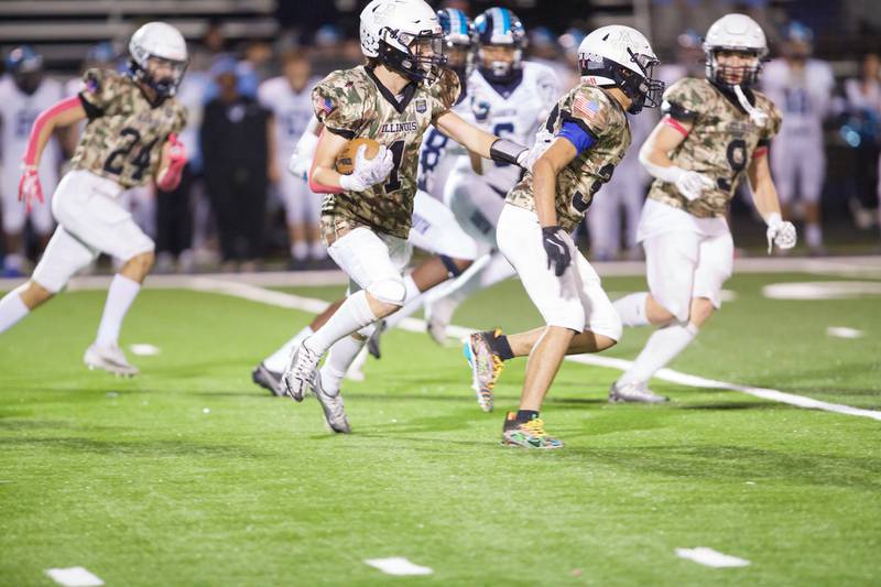 Addison Trails Casey Carlson runs the ball for a gain against Downers Grove South on Friday, Oct.25,2024 in Addison.