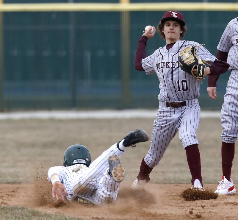Richmond-Burton’s Ryan Scholberg tries to turn a double play as Crystal Lake South’s Dayton Murphy slides into second base during a nonconference baseball game Friday, March 24, 2023, at Crystal Lake South High School.