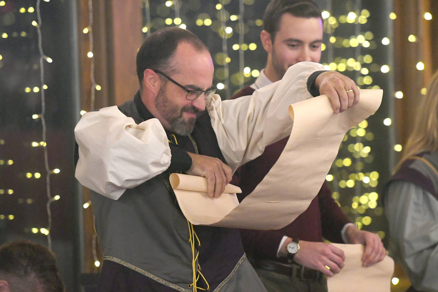 Court jester Fungus (Andy Eckardt) reads instructions from his scroll as Fartlek (Zach Hall) reacts during a scene at Oregon High School's Madrigal Dinner at the Stronghold Camp & Retreat Center on Dec. 9.
