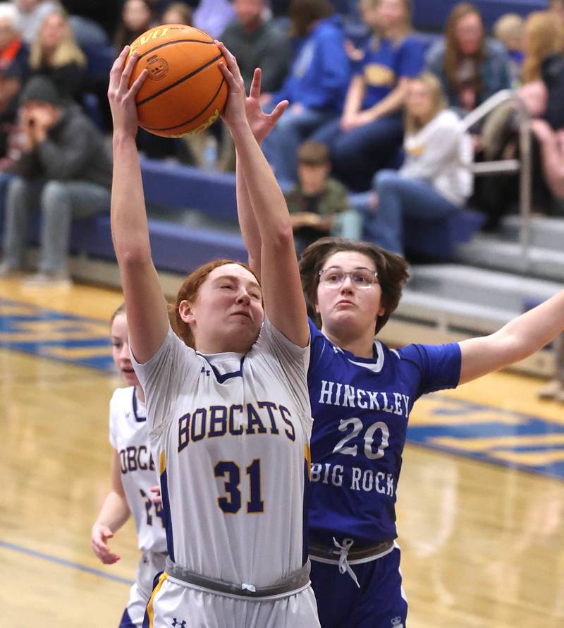 Somonauk/Leland’s Ella Roberts grabs a rebound in front of Hinckley-Big Rock's Grace Hall during their game Thursday, Jan. 15, 2026, at Somonauk High School.