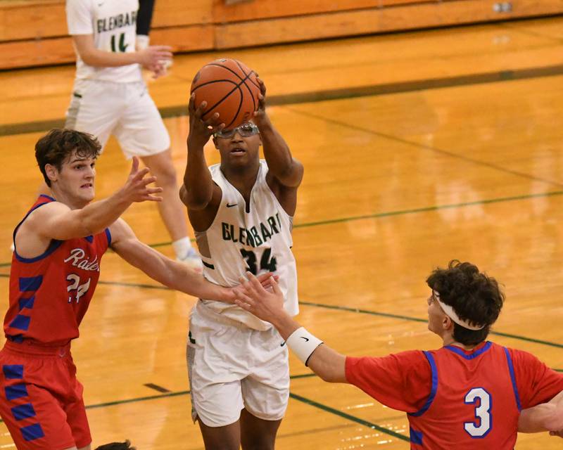 Glenbard South teammates Angjelos Salca (3) and Glenbard South's Harper Bryan, left, along with Glenbard West's Logan Glover (34) go for a loose ball during the second quarter on Monday Nov. 20, 2023, district 87 invite held at Glenbard West.