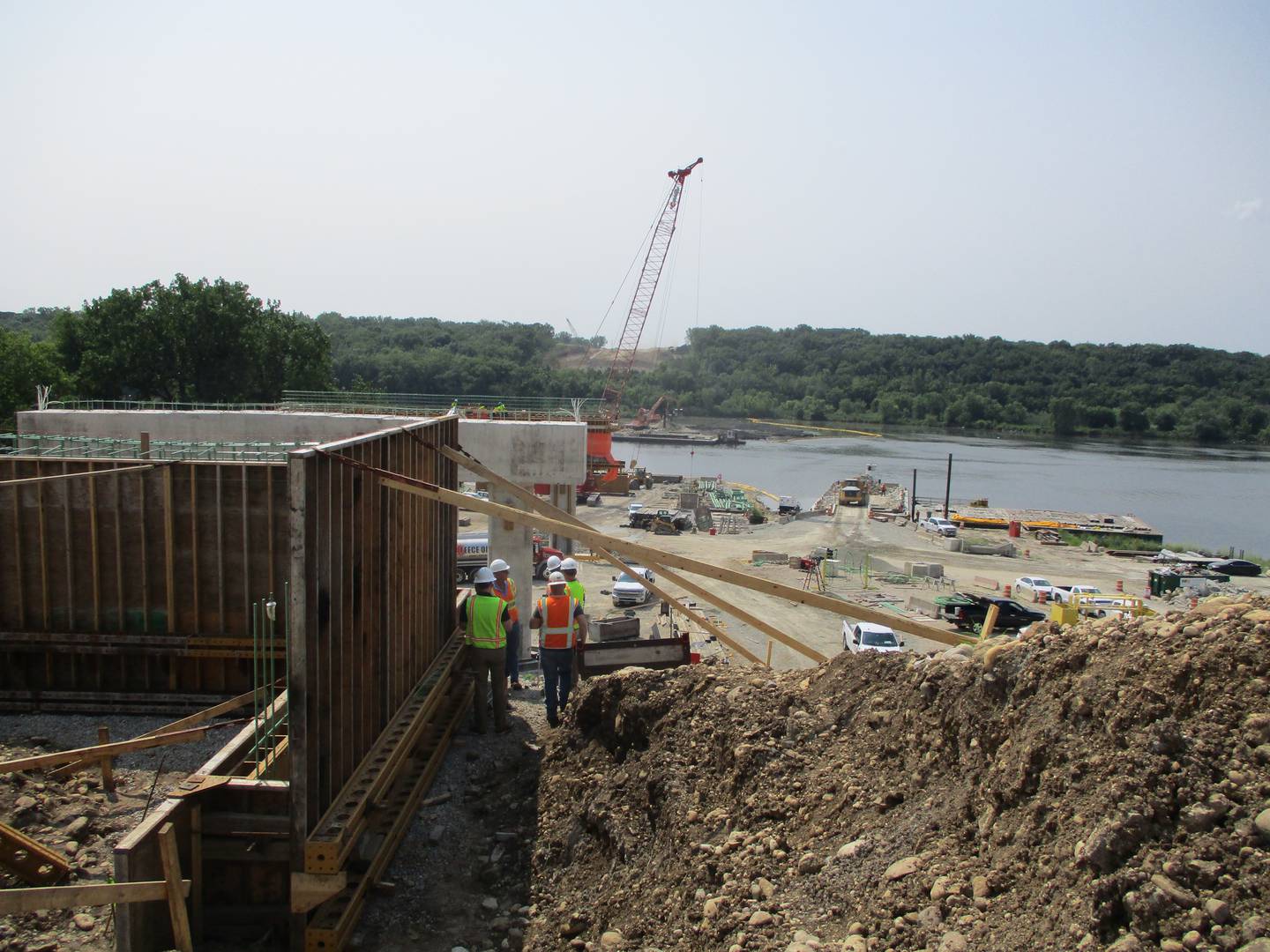 Construction crews work on the Houbolt Road bridge on the north bank of the Des Plaines River in Joliet on Tuesday, July 21, 2021.