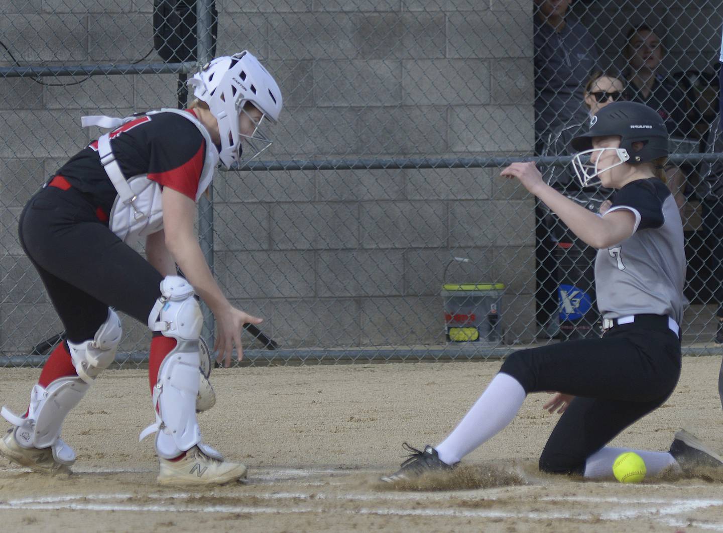 Woodland’s Taylor Heidenreich beats the throw to home to score the second run as Hall catcher Caroline Morris waits to tag in the 2nd inning Tuesday at Woodland.