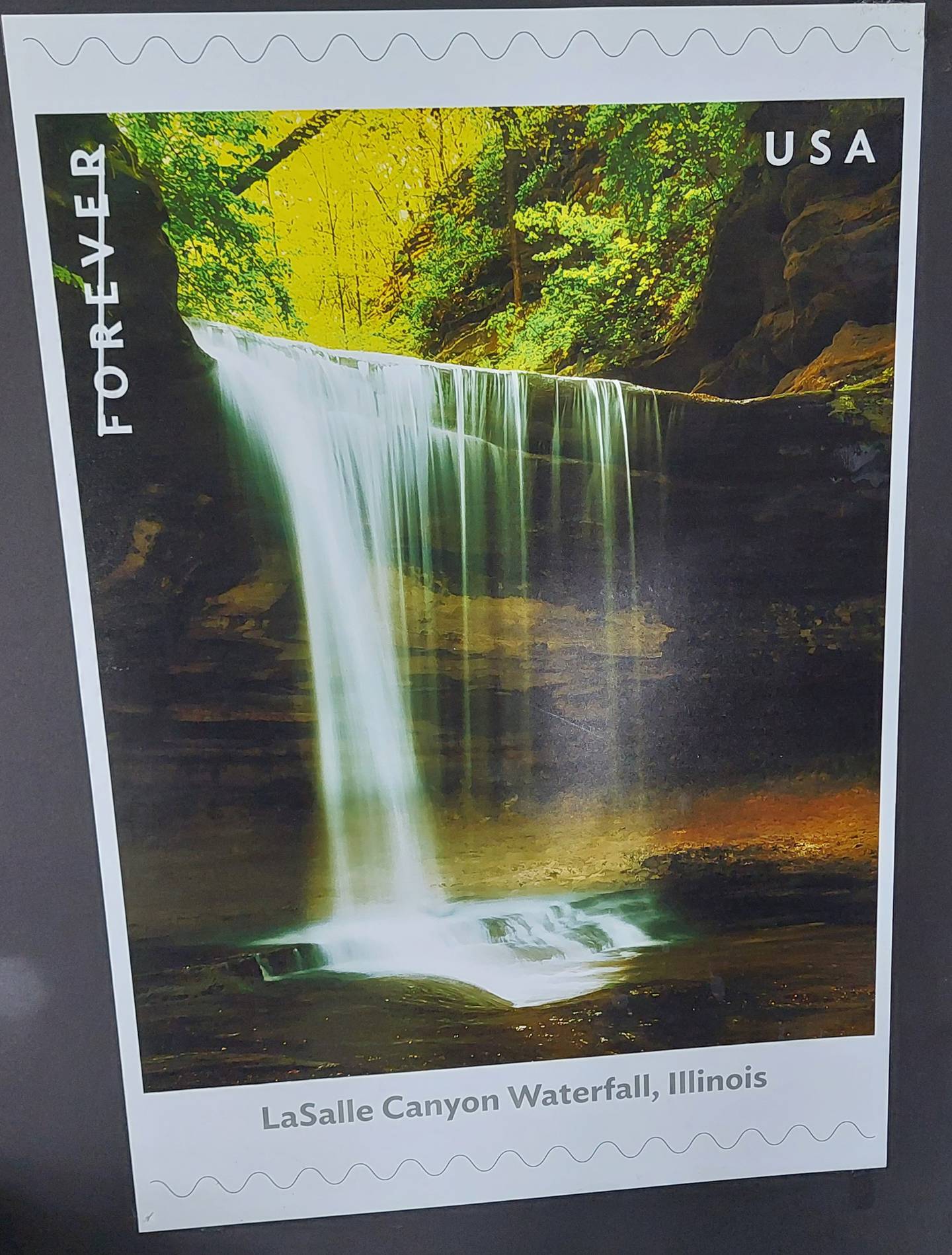 La Salle Canyon Waterfall at Starved Rock State Park is featured on a postal stamp celebrating 12 waterfalls across the United States.
