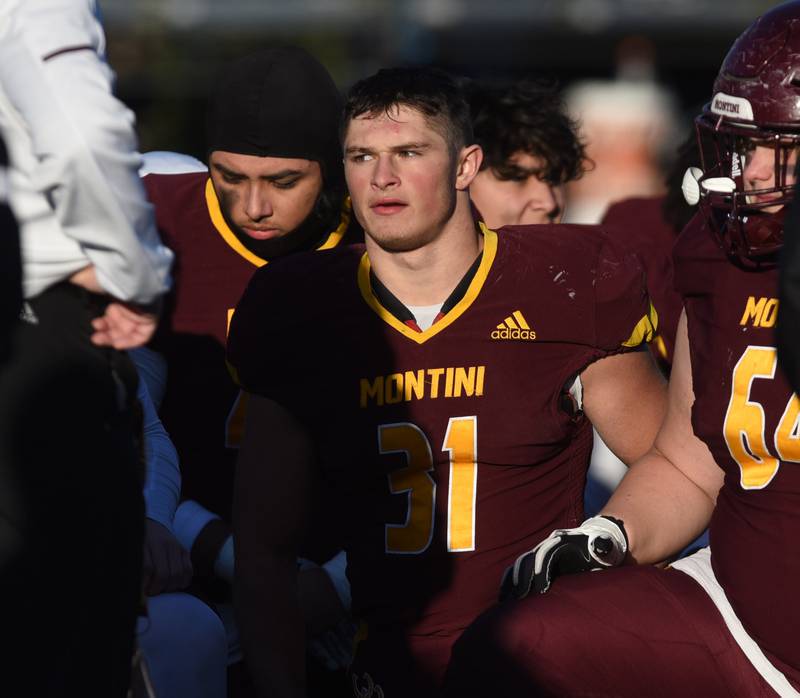 Joe Lewnard/jlewnard@dailyherald.com
Montini's Alex Marre listens to coach Mike Bukovsky speak after the Broncos lost 26-20 to Byron during the Class 3A semifinal game in Lombard Saturday.