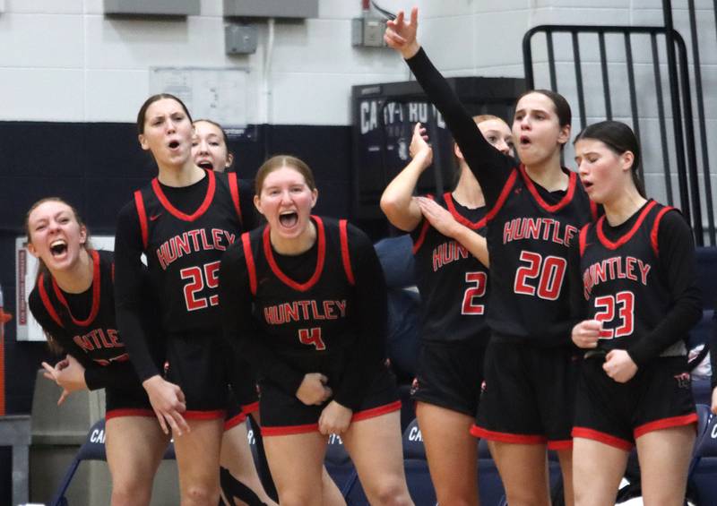 Huntley’s Red Raiders rejoice as they take their first lead of the game on an Ava McFadden three-point shot against Cary-Grove in varsity girls basketball on Friday, Jan. 24, 2025, at Cary-Grove High School in Cary.