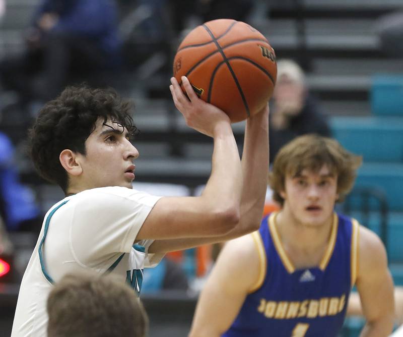 Woodstock North’s Cesar Ortiz shoots a free-thrown as Johnsburg's Jake Metze looks at him in the final minute of a Kishwaukee River Conference boys basketball game Friday, Feb. 10, 2023, at Woodstock North High School.