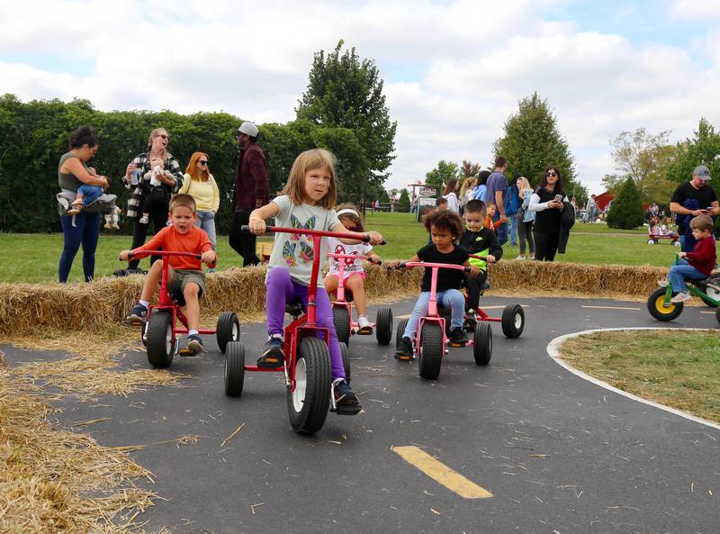 Kids come zooming around the bend at one of the many kid activity sections at Kuiper’s Pumpkin Farm and Apple Orchard in Maple Park on Saturday, Sept. 24, 2022.