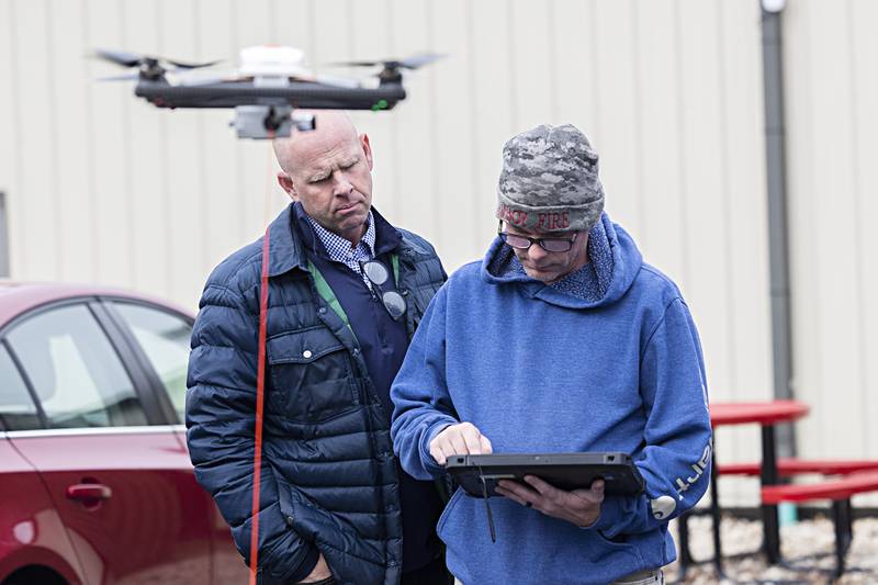 Nick Dinges (left), owner and CEO, of Dinges Fire Company and Nathan Shaw check out a tethered drone known as a kite that can be used for fighting fires, rescue and many other applications.