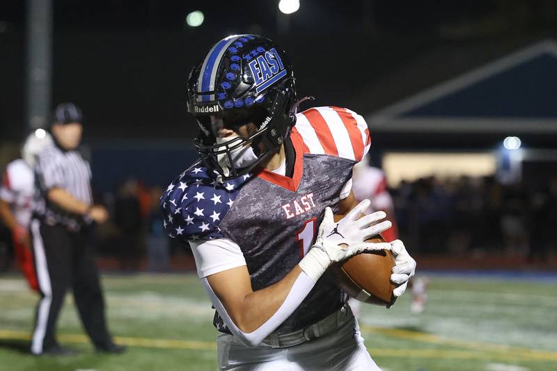 Lincoln-Way East’s Christian Remblake cuts upfield after a catch against Homewood-Flossmoor on Friday, Sept. 27, 2024 in Frankfort.