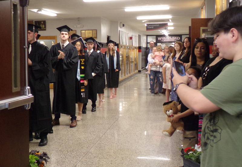 Woodland graduates line up in the hallway Sunday, May 19, 2024, to enter the graduation ceremony in the school's gymnasium.