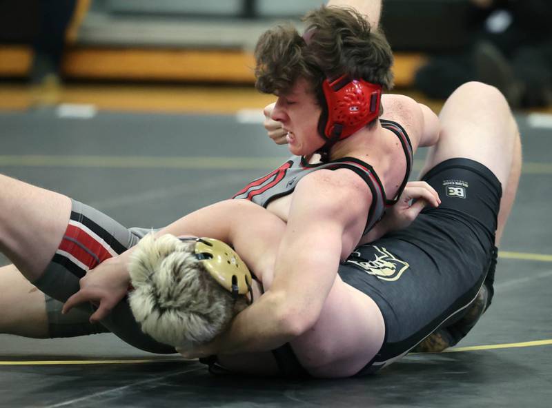 Ottawa’s Andrew Ristau works to pin Sycamore’s Adam Carrick during their 165 pound match Thursday, Dec. 14, 2023, at Sycamore High School.