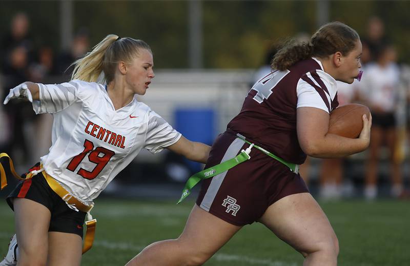 Prairie Ridge’s Alayna Cooper-Turnage runs with the ball as Crystal Lake Central's Mae Anderson tries to grab her flag during a girls flag football game on Thursday, Sept. 4, 2025, at Prairie Ridge High School in Crystal Lake.