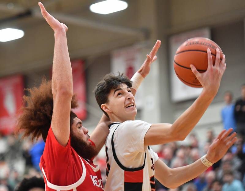 Benet's Niko Abusara goest to the basket in front of Kenwood's Solomon Mosley during a "When Sides Collide" invitational game on Jan. 21, 2023 at Benet Academy in Lisle.