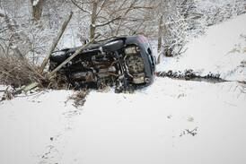 Car rolls down embankment amid heavy snow near Harvard