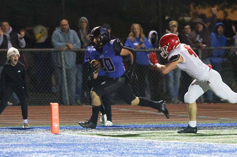 Lincoln-Way East’s Brody Gish rushes for a touchdown against Naperville Central on Friday, Oct. 25, 2024 in Frankfort.