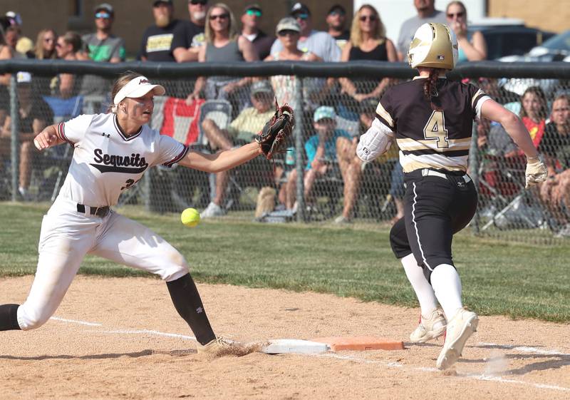 Sycamore's Tia Durst is safe at first as the ball gets by Antioch’s Emily Brecht during their Class 3A supersectional game Monday, June 5, 2023, at Kaneland High School in Maple Park.