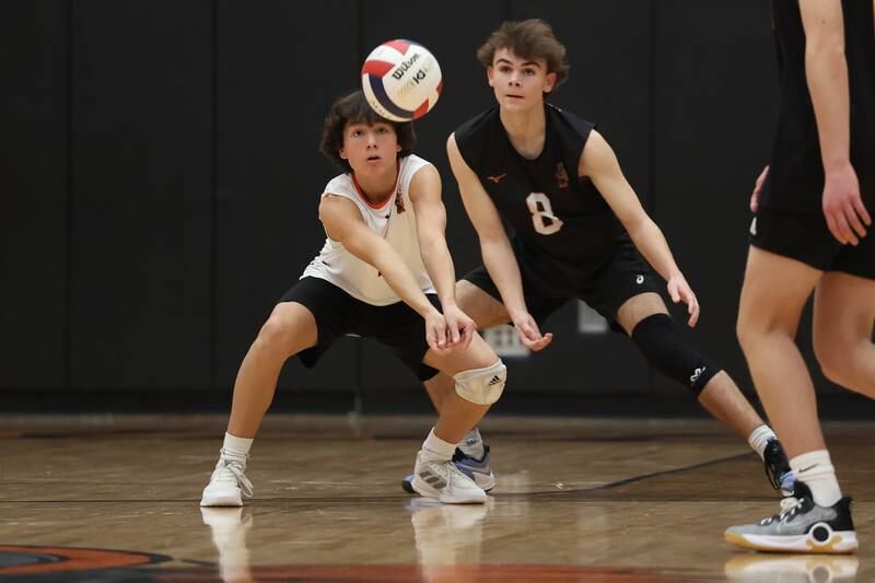 Lincoln-Way West’s Andrew Flores (left) beats Noah Konopack to the dig against Plainfield East on Wednesday, March 22nd. 2023 in New Lenox.