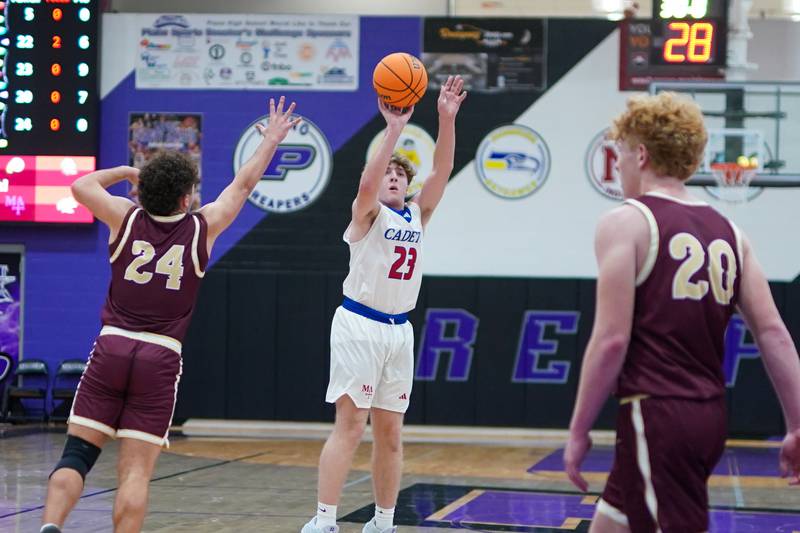 Marmion’s Joseph Kramer (23) shoots a three pointer against Morris’ Colin Pfeifer (24) during a basketball game in the opening round of the 61st annual Plano Christmas Classic at Plano High School on Monday, December 23, 2024.