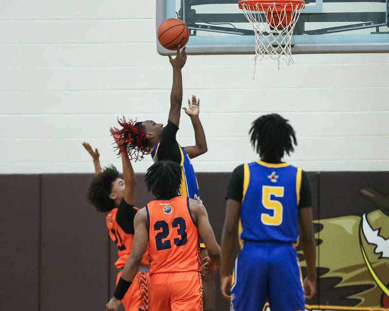 Joliet Central's JaMarcho Holman (1) puts in a lay up in the WJOL Tournament Championship game. Nov 25, 2023.
