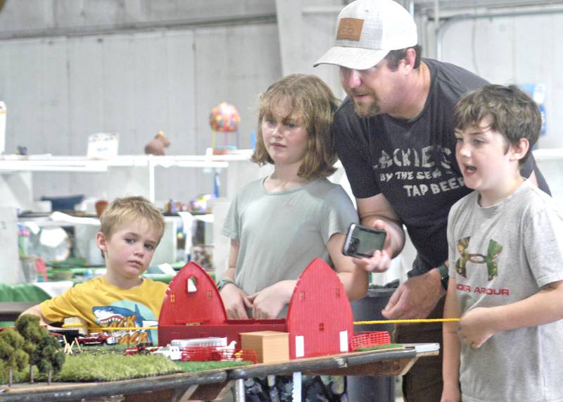 Garrett, Elsie, Levi and Jonah of Paw Paw look over a farm display at the fair on Sunday. Fair action at the Lee County Fair concluded with events Sunday, July 27, 2025.