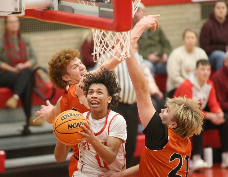 Ottawa's Hizekiah Joachim eyes the hoop while splitting  Sandwich defenders Dom Rome and Noah Campbell miss