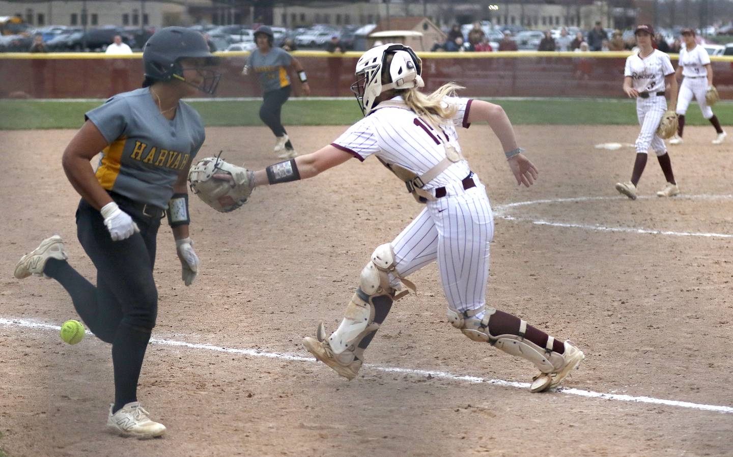 Harvard's Nayeli Sanchez runs to home as the Richmond-Burton's Rebecca Lanz tries to field the throw during a Kishwaukee River Conference softball game on Thursday, April 9, 2026, at Richmond-Burton High School.