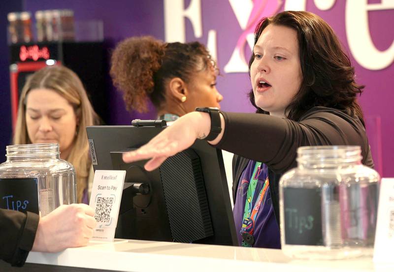 Excelleaf employees are busy helping customers Friday, Nov. 24, 2023, during the soft opening of the dispensary in DeKalb. The business is DeKalb County’s first recreational marijuana dispensary.