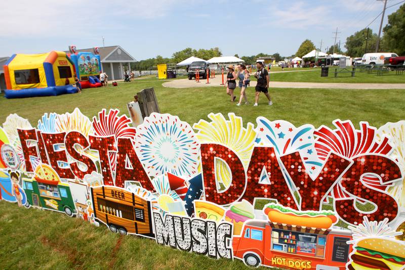 People enter the beach area during Fiesta Days at Petersen Park in McHenry Sunday.