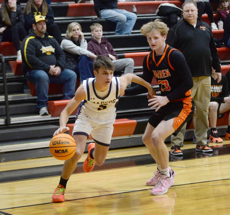 Polo's Gus Mumford (5) drives past Warren's Treyton Pafford during a Tuesday, Dec. 17, 2024 game at the 63rd Annual Forreston Holiday Tournament.