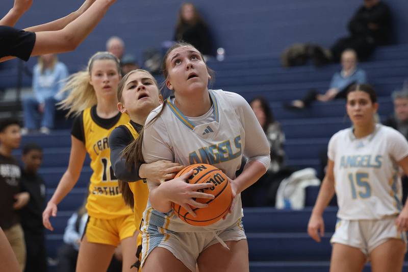 Joliet Catholic’s Lindsey Blabas draws the shooting foul against Carmel on Wednesday, Jan 15, 2025 in Joliet.