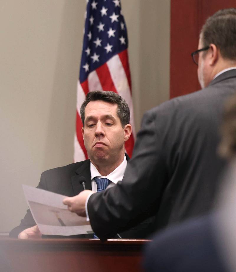 Cmdr. Keith Ehrke, of the DeKalb Police Department, is shown a photo of a piece of evidence by Chip Criswell, lead defense attorney, Thursday, Jan. 30, 2025, during day six of the Jonathan D. Hurst trial at the DeKalb County Courthouse in Sycamore. Hurst is charged in the 2016 killings of elderly mother and son Patricia and Robert Wilson in Sycamore.